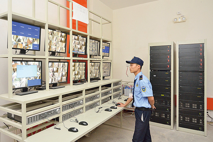 Security guards constantly watch images from surveillance cameras installed in the common areas on the premises of Mandarin Garden.